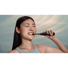Load image into Gallery viewer, Philips Sonicare Series 6100 Electric Toothbrush with Travel Case, Black HX7401/09 - in use