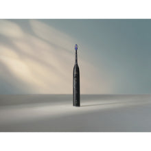 Load image into Gallery viewer, Philips Sonicare Series 6100 Electric Toothbrush with Travel Case, Black HX7401/09 - in use
