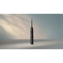 Load image into Gallery viewer, Philips Sonicare Series 7100 Electric Toothbrush with Travel Case, Black HX7421/10 - in use
